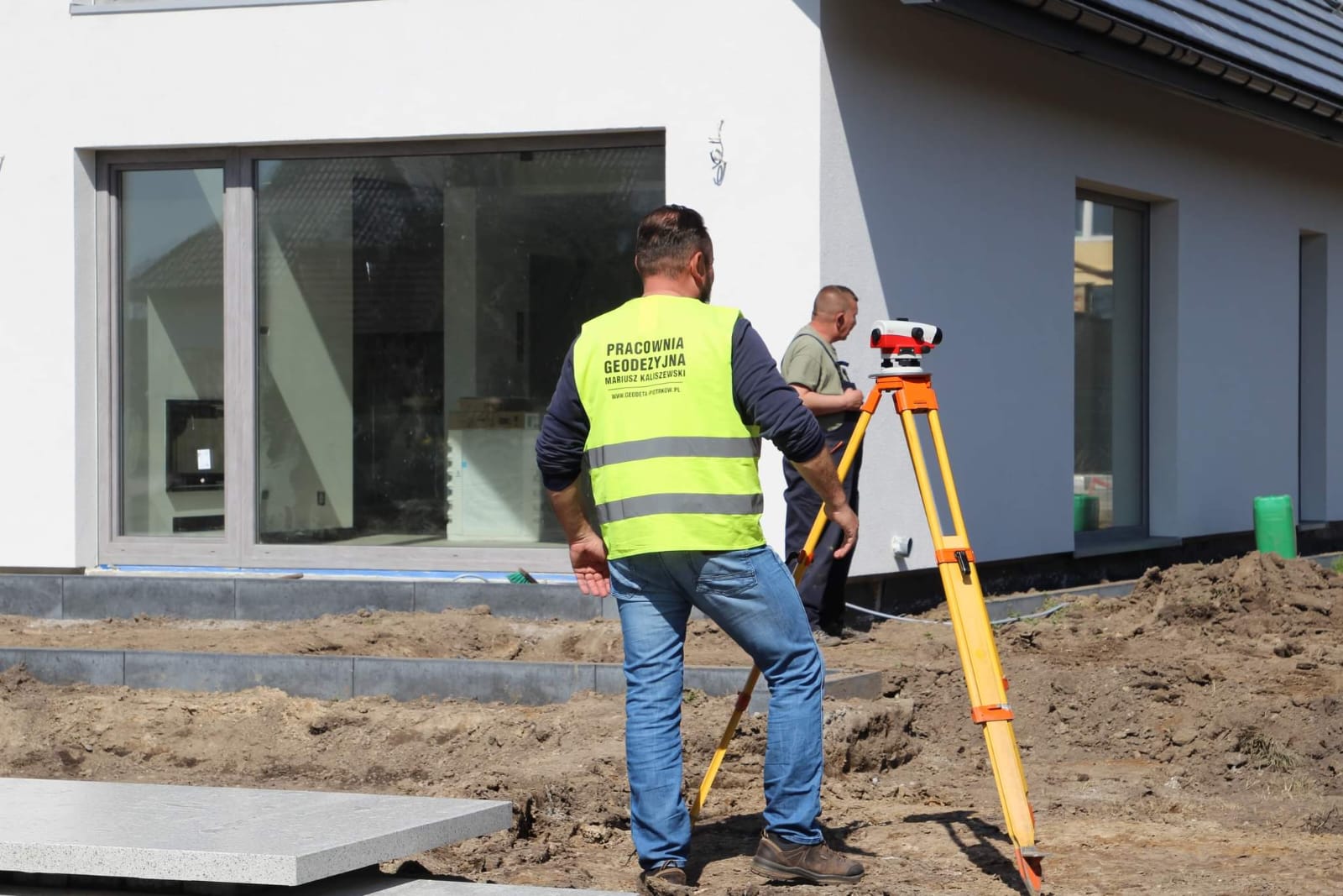 Geodeta wykonujący pomiary przy teodolicie
